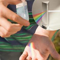 A person holds the PRISM - Fun Educational Science Rainbow Light of Colors by Archie McPhee, as the wonders of optics paint a vibrant rainbow on their hand. An inset reveals light skillfully refracted through another identical prism, forming yet another dazzling rainbow.