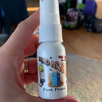 A hand holding a small spray bottle labeled "Liquid Ass," complete with a cartoon character and a portable toilet, is perfectly complemented by the uproarious antics of Le Tooter, the ultimate fart noise maker in any prankster's toolkit.