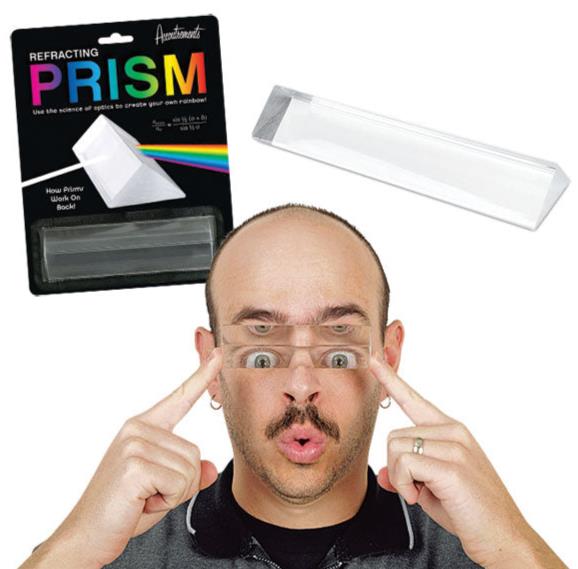 A person holding the PRISM - Fun Educational Science Rainbow Light of Colors by Archie McPhee gazes through its mesmerizing optics. In the background, the packaging suggests a spectrum of possibilities this prism offers.