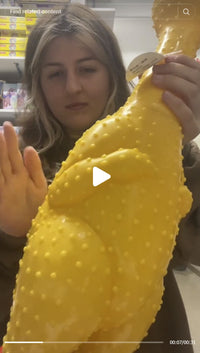 Someone holds and taps the GIANT 27" Rubber Chicken—the biggest, loudest squeaky toy and a hilarious gag gift—in a store aisle.