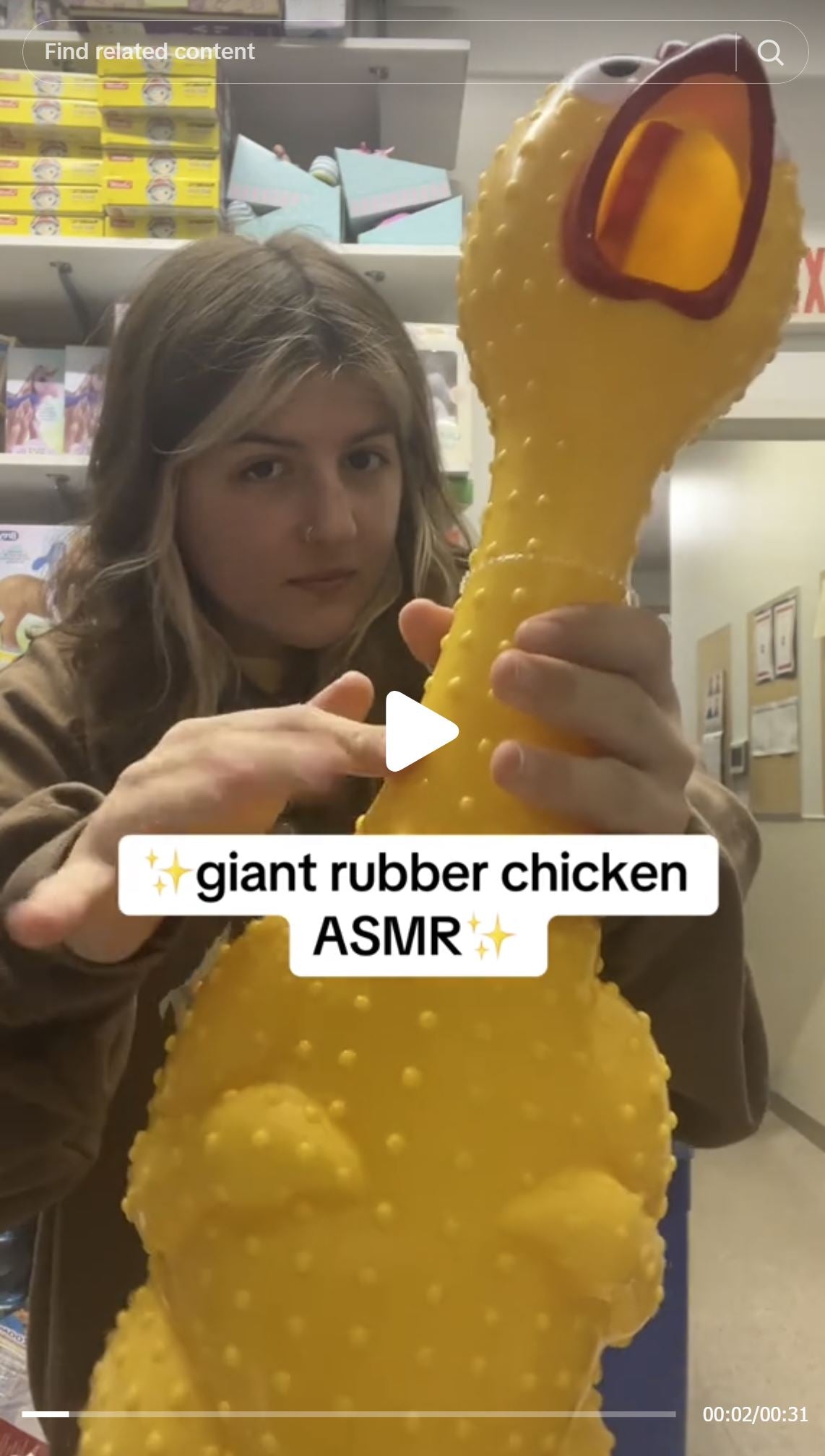 Person taps and squeezes the 🐔 GIANT 27" Rubber Chicken – Biggest & Loudest Squeaky Toy, making ASMR sounds in a store or storage room. Text overlay: "giant rubber chicken ASMR.