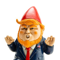 A quirky addition to your yard decor, the DONALD TRUMP GARDEN GNOME from BigMouth features a funny design with orange hair and beard, a red hat, blue suit, red tie, and an American flag pin as it holds up both hands in a gesture.