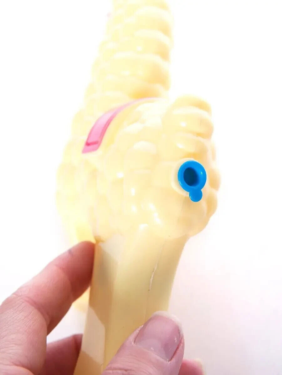 A quirky SPITTIN' LLAMA Water Pistol Squirt Gun with a blue nozzle is playfully gripped in hand.