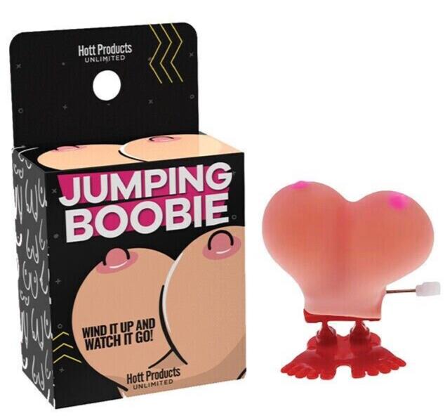 A novelty toy called "1 Jumping Boobie & 1 Pecker - Wind up Set - Funny Hen Party Novelty Adult Gift" is shown next to its packaging. The toy, featuring a wind-up mechanism and shaped like a pair of pink breasts with red feet, is perfect for adding a cheeky twist to kids' birthday parties or as hilarious party decorations.