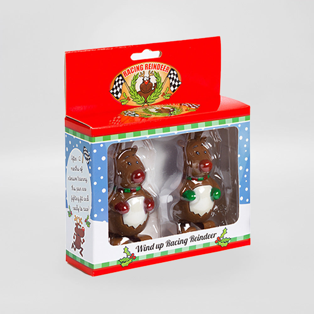 Box of two Racing Reindeers, perfect for a hilarious holiday gift or stocking stuffer. Encased in festive packaging with a playful label, these wind-up toys promise endless fun and laughter for the season.