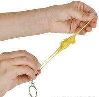 Hands stretching one of our 3" Rubber Stretch Chicken Keychains from the 12-pack, perfect as quirky piñata fillers or party prizes.