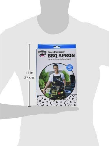 Packaging of "THE GRILL SERGEANT BBQ APRON Barbeque Party Gift Prank Beer Holder Humor Joke," featuring a fun gag gift design with an image of a man wearing the camouflage grilling apron. The packaging indicates dimensions as 11 inches (27 cm) tall.