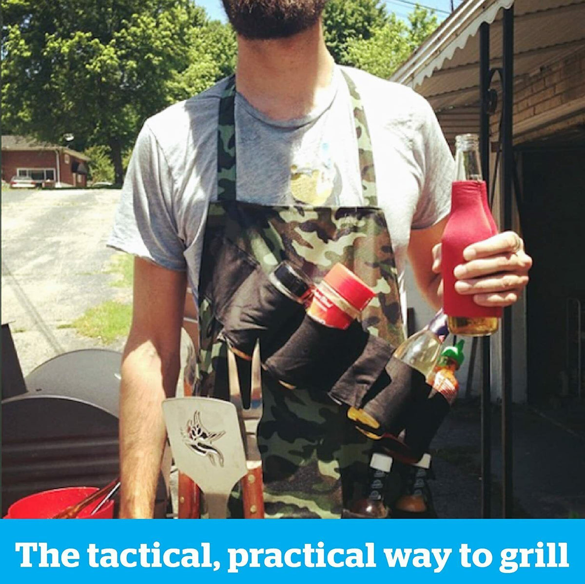 A person wearing THE GRILL SERGEANT BBQ APRON, which is equipped with multiple pockets holding grilling tools and condiments, while holding a drink in one hand. Text below reads, "The tactical, practical way to grill—a fun gag gift for any backyard hero.