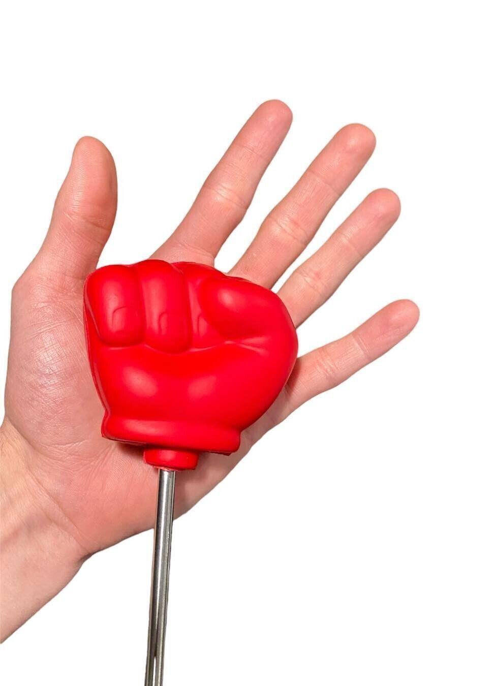 A hand holds the Giant 22" Extending Boxing Punch Glove - Snore-no-More! against a white background—perfect as a funny gag prank joke toy.