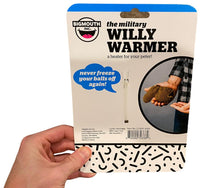 A person holds packaging for the "ARMY MILITARY Willy Warmer Weiner Weener Knitted Sock - Adult Gag Joke Gift," a product by BigMouth Inc. designed to keep genitalia warm. The package showcases a knitted warmer and contains humorous text promoting this hilarious gag gift.