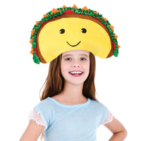 A smiling young girl with long hair wears a large TACO HAT - Sombrero Headband Cap Food-Prop-Smiley-Halloween Funny Party Costume and a light blue shirt with lace sleeves, looking like she just stepped out of one of those funny viral videos.