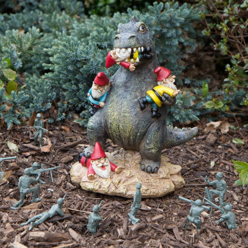 The BigMouth Inc. The Great Massacre Garden Gnome T-Rex Outdoor Statue features a dinosaur attacking gnomes, styled after the Great Garden Gnome Massacre—perfect for adding bold humor to your garden.