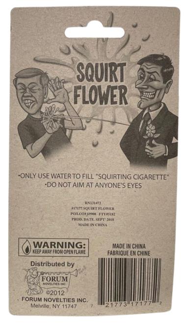 Back view of the "Classic Lapel SQUIRT FLOWER Clown Rose Joke Prank Squirting Water Formal Costume" packaging with cartoon illustrations, perfect as a prank gag gift. Warning messages and barcodes are visible along with details on the manufacturer, distribution, and usage instructions for this classic clown gag.