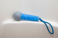 Close-up of the Microphone Soap On Rope - Rock on while cleaning up your butt! by BigMouth Inc, featuring a blue design with a braided cord, resting on a wet surface—perfect for shower concerts.