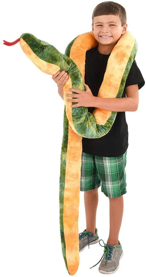 A boy in a black t-shirt and green plaid shorts holds a Giant 100 Inch Long Anaconda Snake Plush Stuffed Animal Toy with realistic markings.