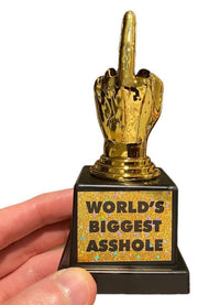 A hand holding a trophy shaped like a hand giving the middle finger, with the label "World's Biggest AS%HO#E," makes for a perfect humorous gift.