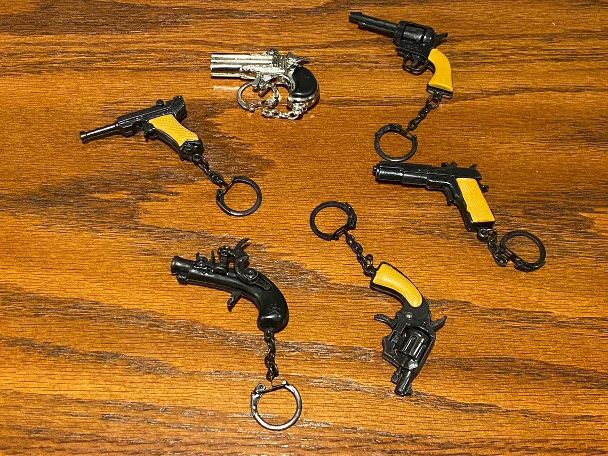 12 Vintage 80's mini key chain diecast metal pistol cap gun - die cast display