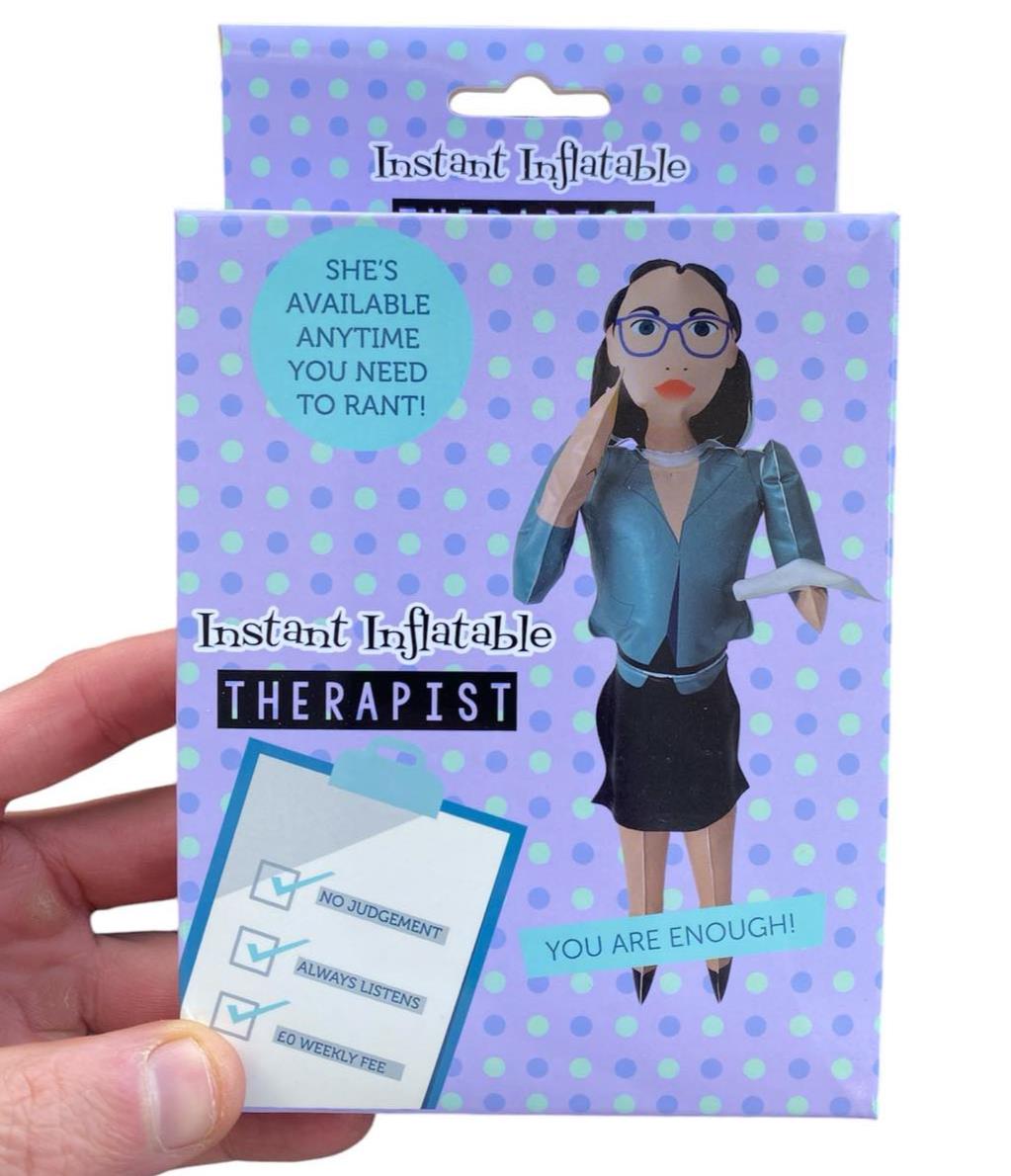 The "Inflatable Blow Up Therapist - RANT ANYTIME - Novelty Stocking Stuffer Gag Gift" comes in amusing packaging that features a cartoon therapist figure marked with checks for "No Judgment," "Always Listens," and "No Weekly Fee." This gag gift is a fun addition to any collection, providing humor and support with no hassle.