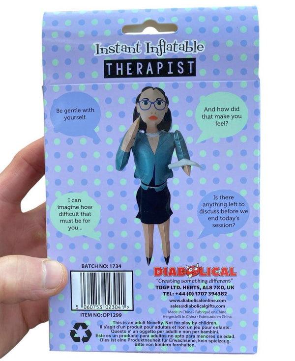 A hand holds a box for an "Inflatable Blow Up Therapist - RANT ANYTIME," a perfect novelty stocking stuffer gag gift featuring a cartoon therapist figure with speech bubbles on a polka dot background.