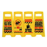 The ⚠️ 4 Pack Funny Warning Desk Signs ⚠️ make a perfect office gag gift, featuring humorous caution messages about coffee needs, no poo zone, genius at work, and dangerous desk space.