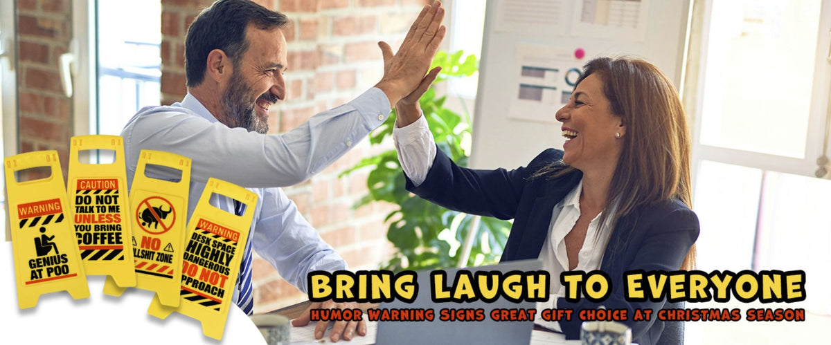 Two people in business attire smiling and high-fiving at a table with the ⚠️ 4 Pack Funny Warning Desk Signs ⚠️—a hilarious Office Caution Humor Gag Gift Potty Set, perfect for spreading Christmas cheer at work!.