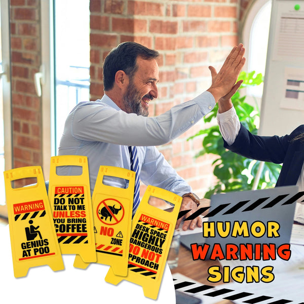 Two people in business attire high-five in an office, with the ⚠️ 4 Pack Funny Warning Desk Signs ⚠️ Office Caution Humor Gag Gift Potty Set 🎁 displayed—hilarious workplace gag gifts for lighthearted colleagues.