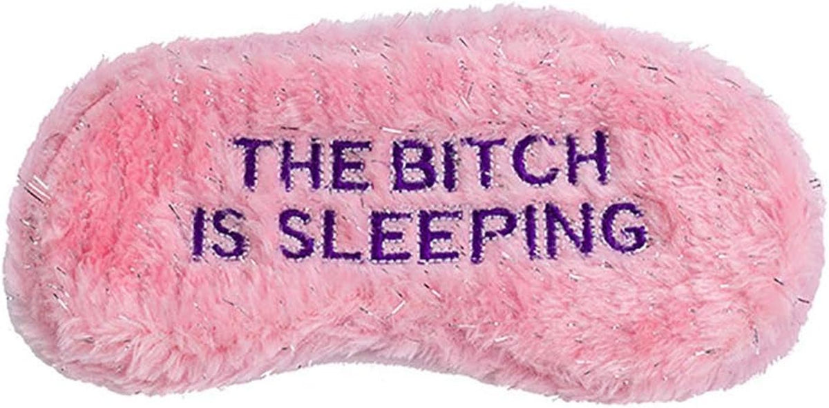 The "THE BITCH IS SLEEPING" Mask, a soft pink fluffy eyemask with purple embroidery, makes a hilarious novelty gift and perfect funny sleep accessory.