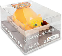 Squishy yellow stress cat toy packaged in a clear box, labeled: "Purrrly Kitty Cat in a Box." Suitable for ages 3 and up. Available from Archie McPhee with color options.