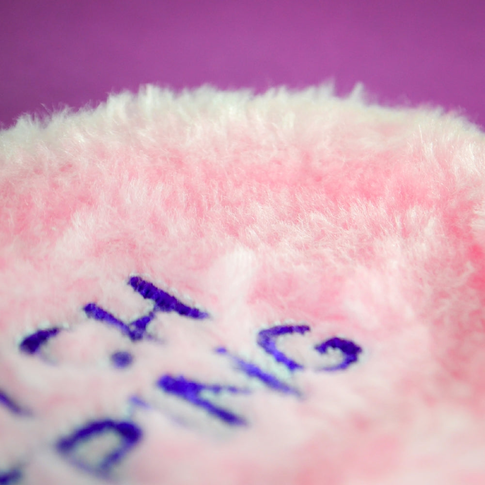 The pink fluffy "THE BITCH IS SLEEPING" mask, featuring partly visible blue embroidery on a purple background, is a quirky novelty gift. Ideal as a funny sleep accessory, it's perfect for adding humor and style to your slumber routine.