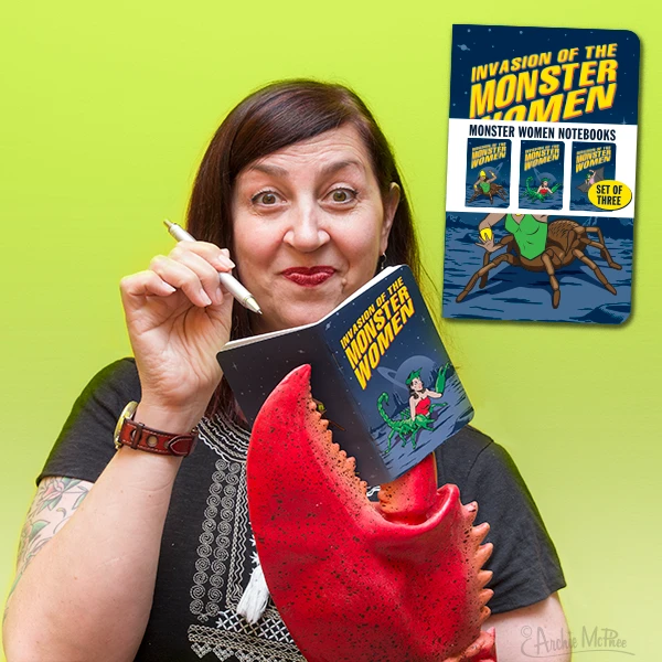 A woman is holding a Monster Women Notebook from the 3PK Monster Women Notebook Journals Note Pad GIRL POWER! by Archie McPhee, featuring a red claw against a vibrant green cover with the bold declaration "Invasion of the Monster Women"—a perfect gift for fans of female monsters.