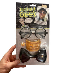 A hand displays the Instant Geek Costume Kit 🤓 featuring glasses, fake teeth, bow tie & pimple—a hilarious nerd dress up set perfect for costumes or parties!.