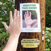 A person high fives a hand image on a sign attached to a wooden post. Below, there's a humorous warning: "No posting of advertising signs unless they're really awesome." This could be inspired by the "23 Page Hilarious Poster Signs - Prank your neighborhood - Funny Gag Joke," known for blending humor with everyday moments much like Jeff Wysaski's work.