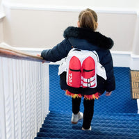 A child wearing a jacket and the Kids Jetpack Backpack Rocket School Bag 🚀 Space Astronaut Costume Travel Gift walks up a blue-carpeted staircase.