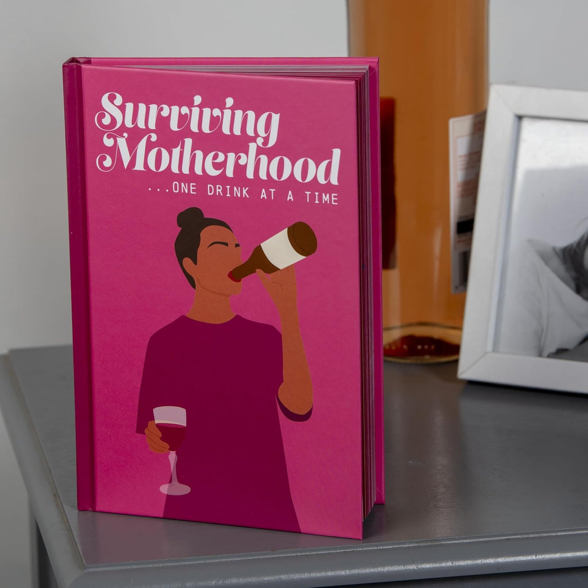 Surviving Motherhood... One Drink at a Time Hardcover Book - Funny Gag Joke Gift