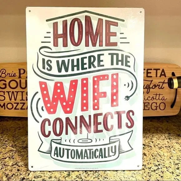 The Metal Tin Sign "Home is Where the WIFI Connects Automatically" Wall Decor #H-101 features a witty message and stylish decorative elements, making it an ideal charming gift that adds modern humor to any home decor.