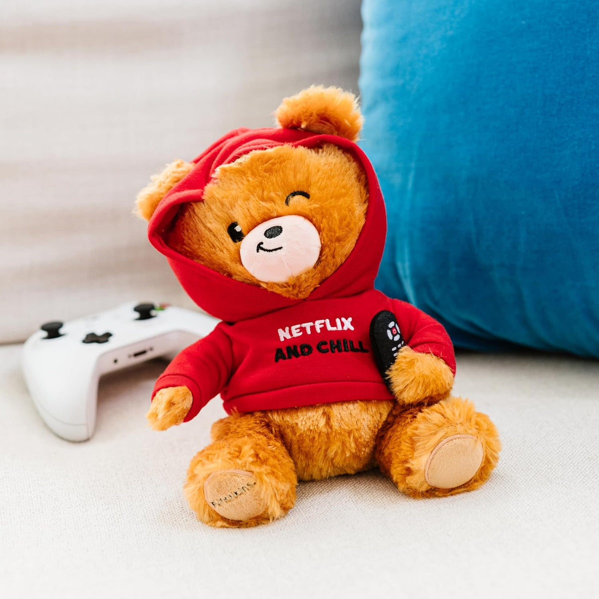 The Punchkins 🐻 "Netflix & Chill" Teddy Bear Plushie 📺, wearing a red hoodie and holding a remote, is the perfect cuddly movie fan gift and plush companion for cozy nights in.