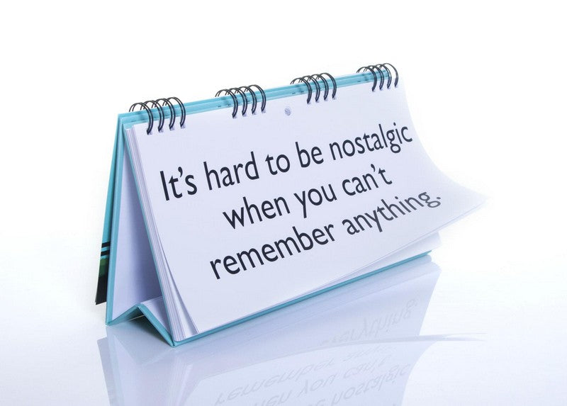 A memorable flip calendar titled "Senior Moments - Desk Spiral Flip Book – Over Hill Message Table Desk Signs" showcases the amusing message, "It's hard to be nostalgic when you can't remember anything," making it an ideal funny retirement gift.