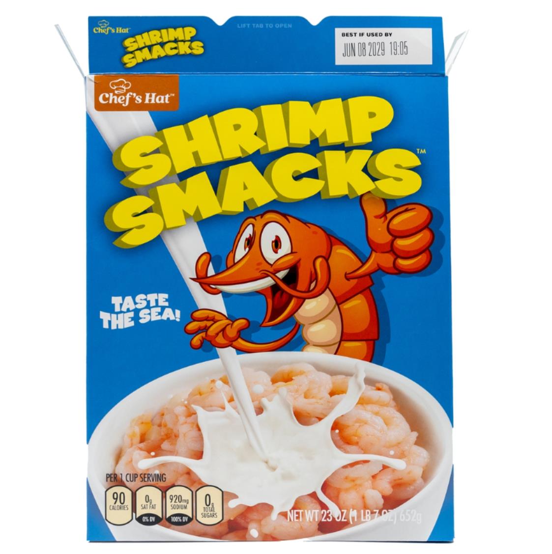 The 🦐 Prank Cereal Box – Shrimp Smacks Gag Gift Box features a blue box with a cartoon shrimp, milk splashing onto shrimp pieces, nutrition info, and the "Taste the Sea!" slogan—perfect for pranks or as a funny joke present.