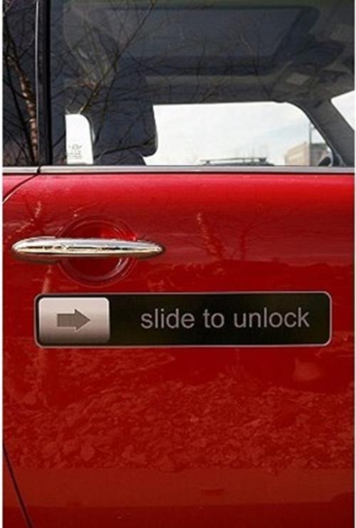 A 17-inch RETRO Slide to Unlock Magnet by Big Mouth Inc, designed for iPhones, iPods, cars, and fridges, features a red car door with a silver handle and includes a "slide to unlock" sign with a right-pointing arrow.