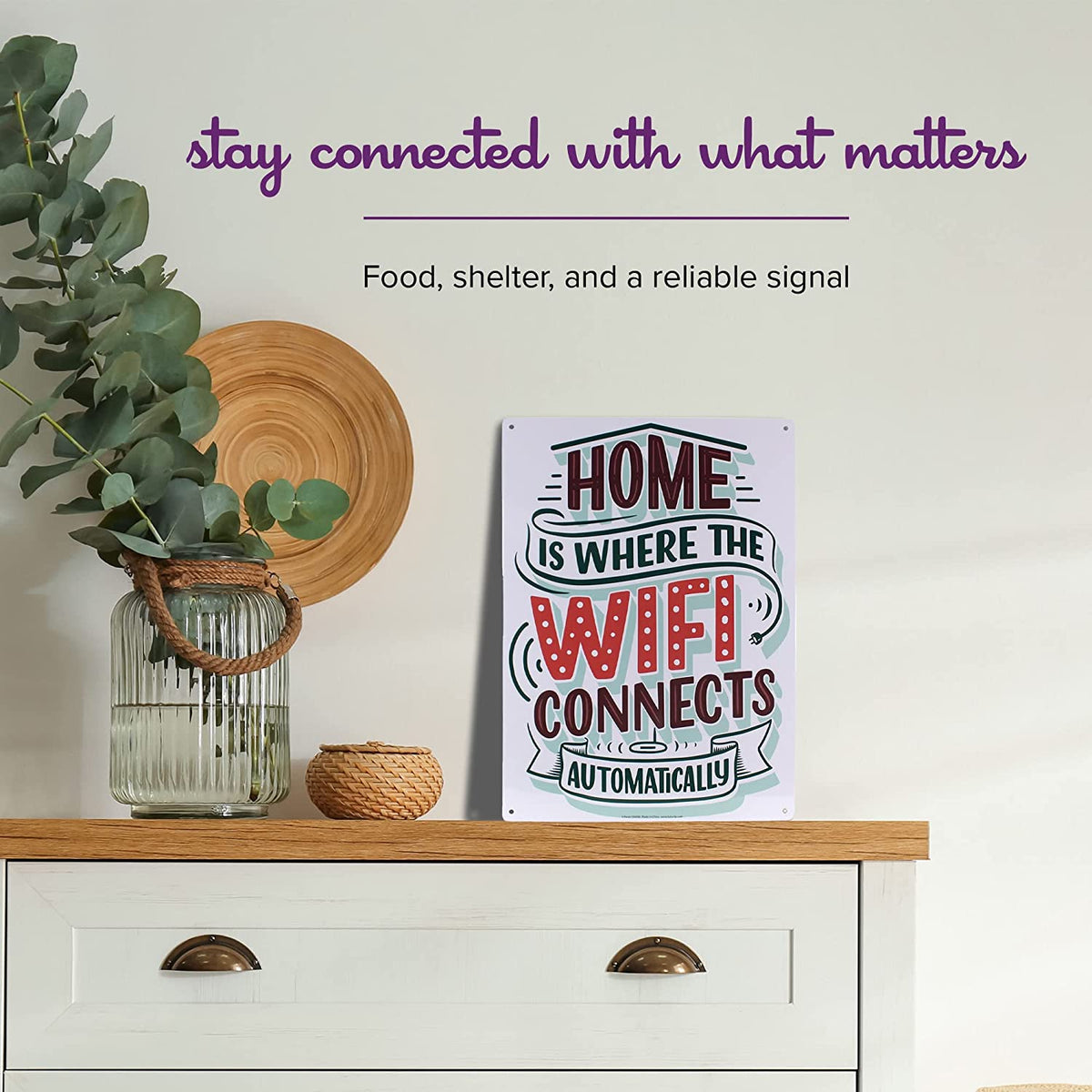 Nestled on a shelf with plants and a basket, the Metal Tin Sign "Home is Where the WIFI Connects Automatically" Wall Decor #H-101 makes a charming statement. This delightful piece offers both a unique gift idea and an ideal enhancement to your home decor.