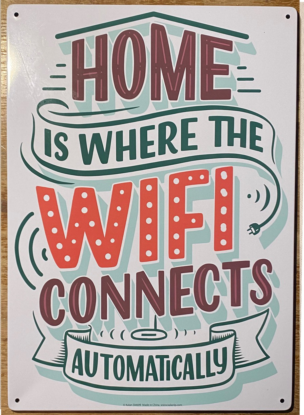 The Metal Tin Sign "Home is Where the WIFI Connects Automatically" Wall Decor #H-101 showcases the playful phrase, making it an ideal gift for those who enjoy quirky home decor.