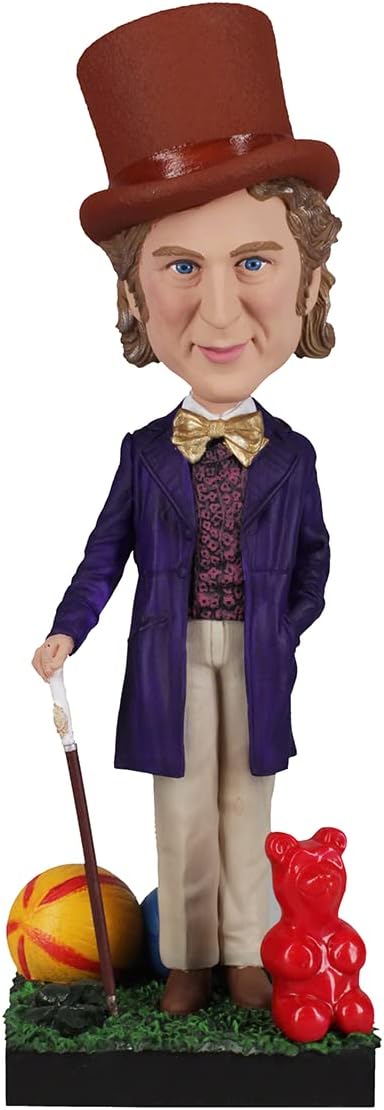 The Willy Wonka Bobblehead Statue – Gene Wilder Collectible Figure by Royal Bobbles features Willy in a purple coat with cane, standing beside a red gummy bear and colorful ball on a grassy base.