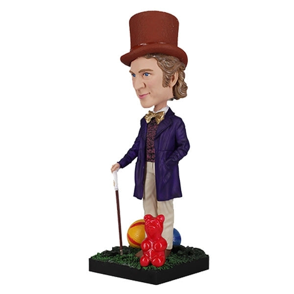 The Willy Wonka Bobblehead Statue – Gene Wilder Collectible Figure by Royal Bobbles🍬 features a hand-painted figure in a purple coat and brown top hat, holding a cane, standing on grass with colorful balls and a red gummy bear.