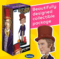 A Royal Bobbles Willy Wonka Bobblehead Statue – Gene Wilder Collectible Figure stands beside its box, both displaying the hand-painted movie figure in a purple coat and top hat for a unique collectible package.